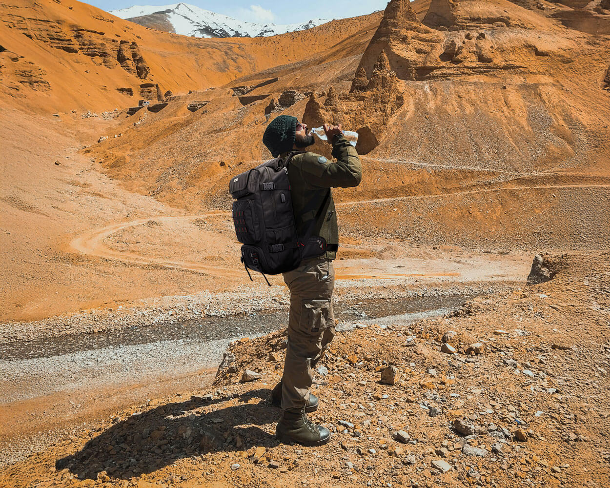 Desert adventure, drink water to quench thirst, travel backpack for men